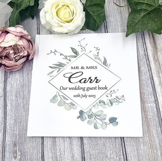 Beautiful personalised wedding guest book with eucalyptus wreath design and couples names and wedding date.