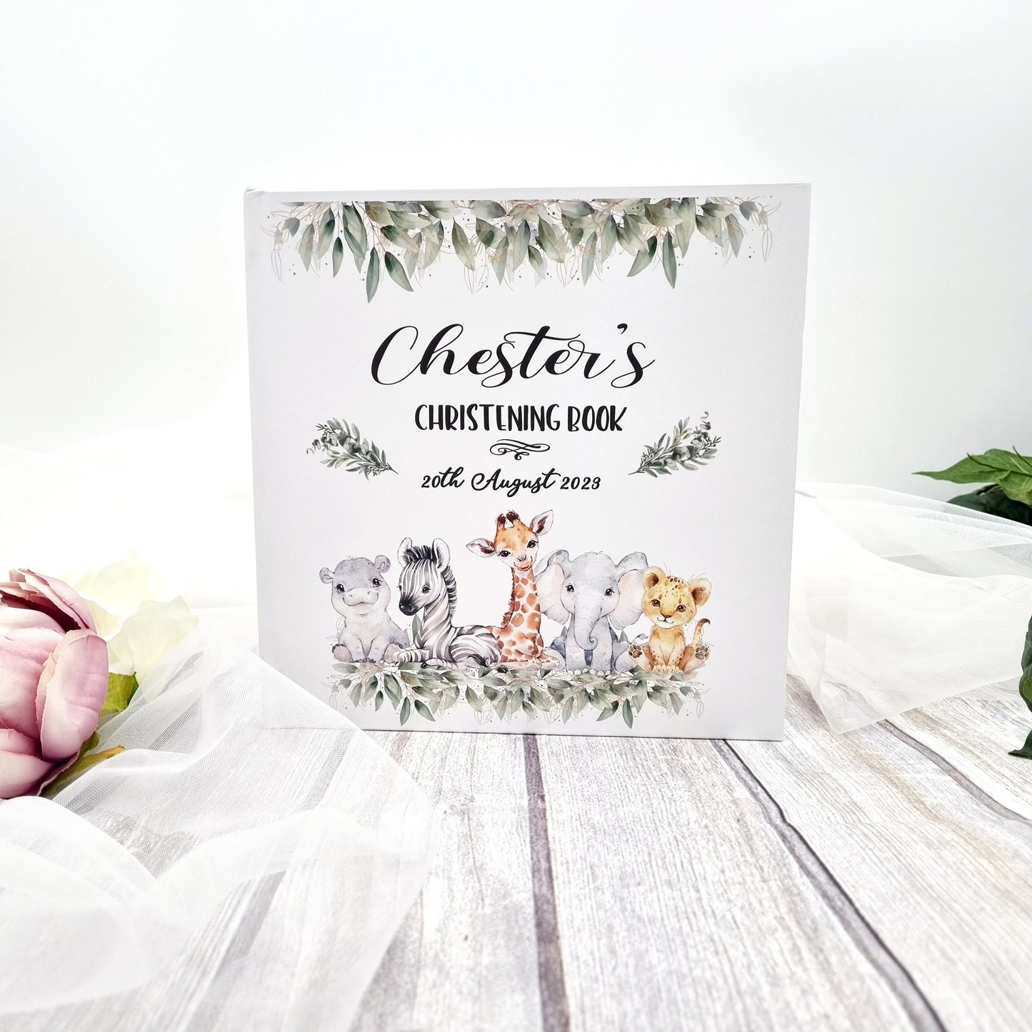 Christening guest book with animal safari design on the front from hanaLee Studios. Baby's details written on the front.