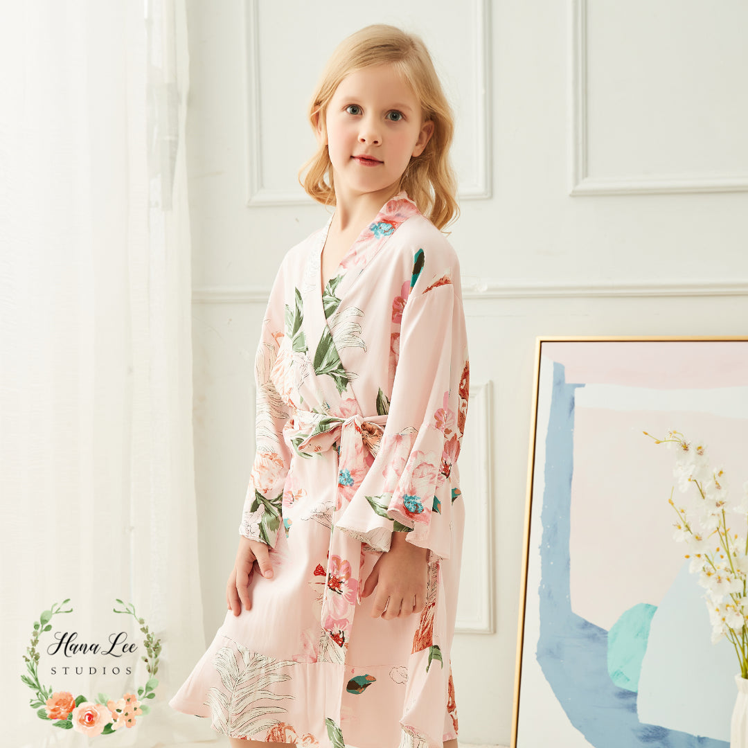 Flowergirl wearing blush pink personalised floral satin robe — elegant kids wedding robe designed and finished in Ireland by HanaLee Studios