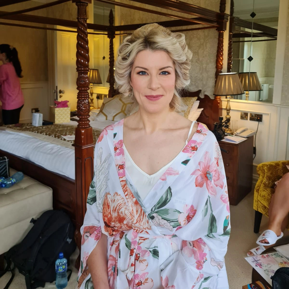 Bride wearing her white floral pattern robe from HanaLee Studios on the morning of her wedding