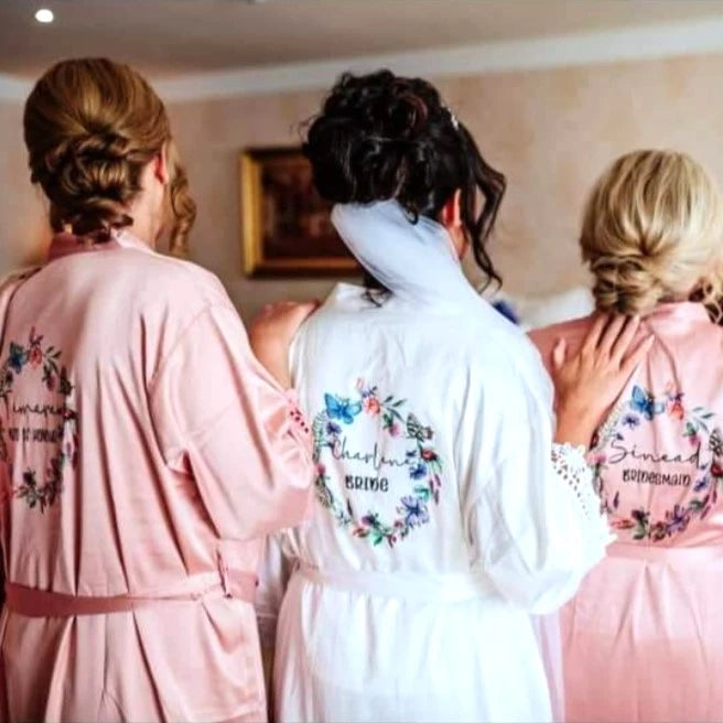 Dusty rose pink bridesmaids robes with white bridal robe and butterfly wreath design, personalisaed with name and title