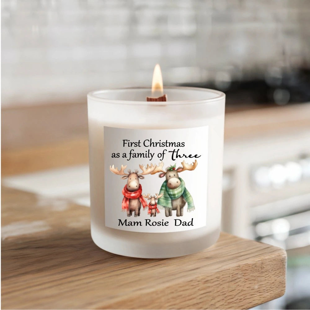 Personalised soy candle with festive design reading “First Christmas as a Family of Three” with moose family illustration – hand-poured in Ireland.