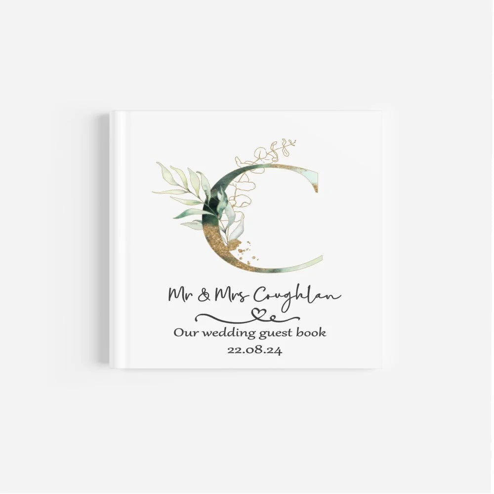 Personalised wedding guest book with green & gold initial design and couples details and wedding date.