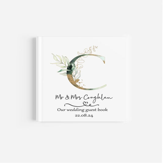 Personalised wedding guest book with green & gold initial design and couples details and wedding date.