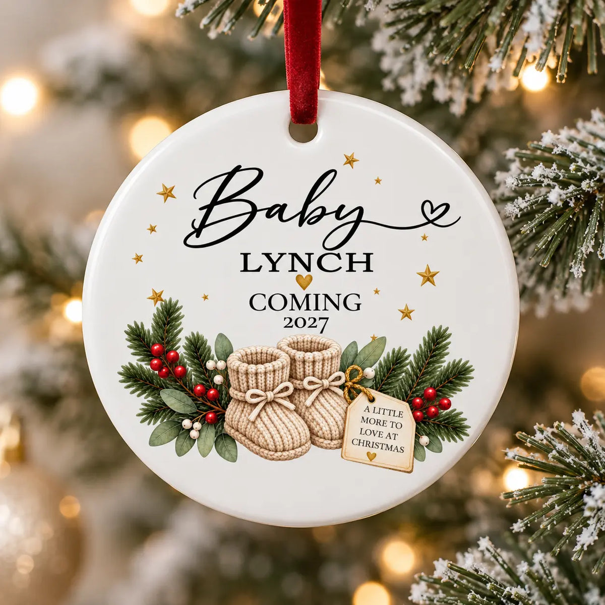 Personalised Baby Coming 2027 ceramic Christmas decoration with surname, baby booties and red velvet ribbon