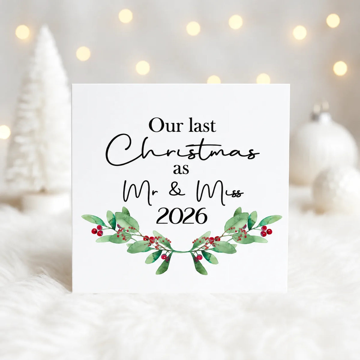 Two personalised Our Last Christmas as Mr & Miss 2026 mugs with red handles, festive eucalyptus leaves and red berry design.