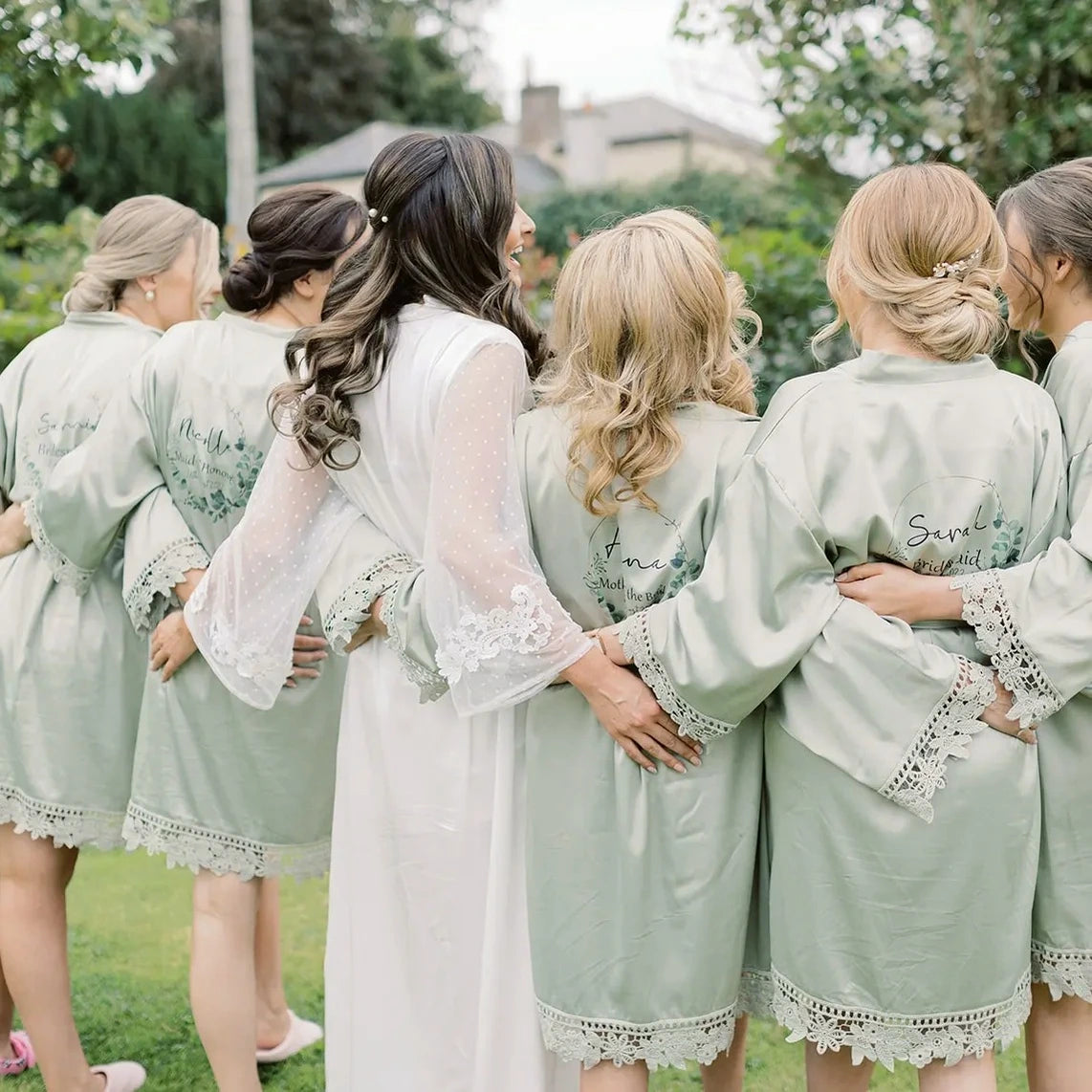 Bride and bridesmaids wearing personalised satin lace wedding robes