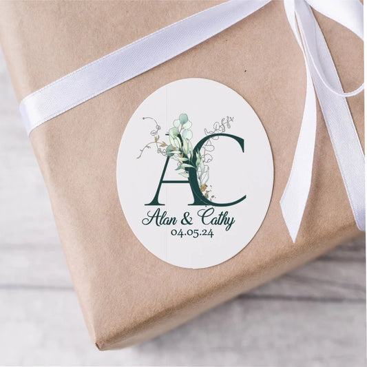 Customised wedding stickers with dark green initials of the couple, their names underneath and wedding date.