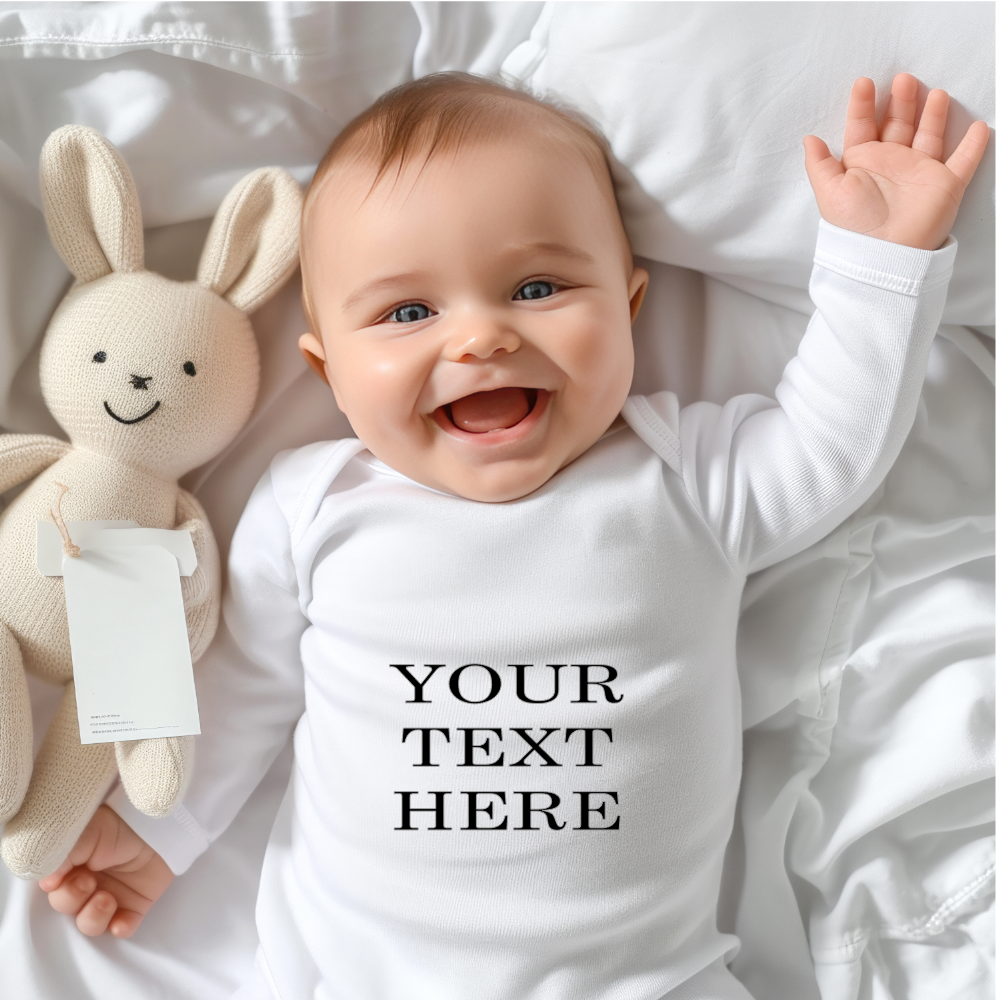 A baby wearing a white romper suit with a personalized text 'YOUR TEXT HERE' on the front, accompanied by a grey rabbit toy.