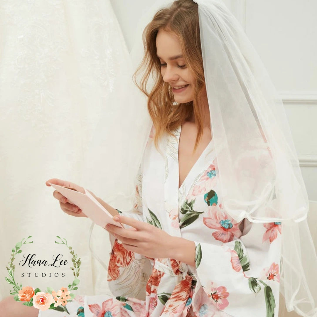 Bride wearing white floral personalised robe on wedding morning – Irish made custom robe from HanaLee Studios