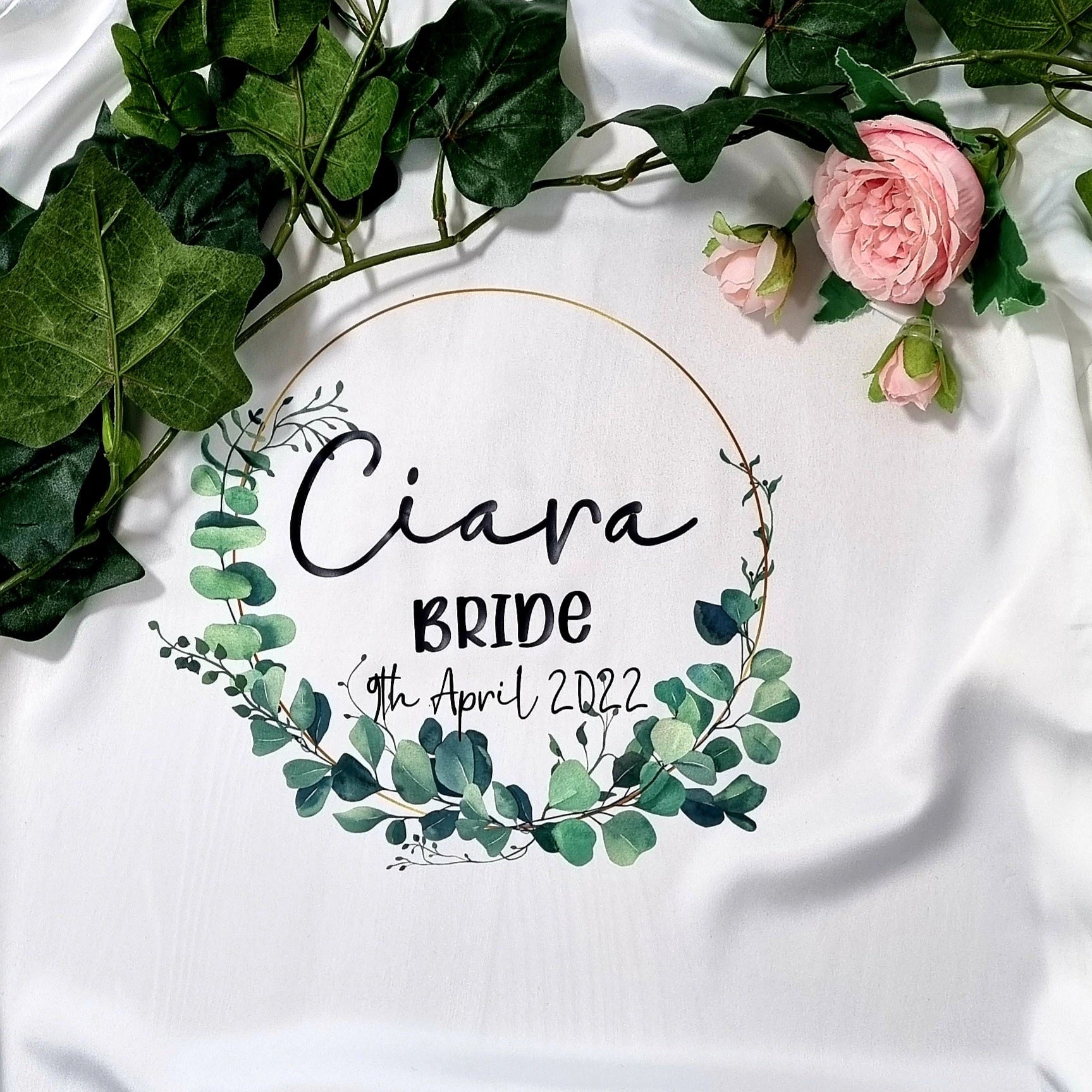 Close-up of lace trim and wreath design personalization on bridal robe