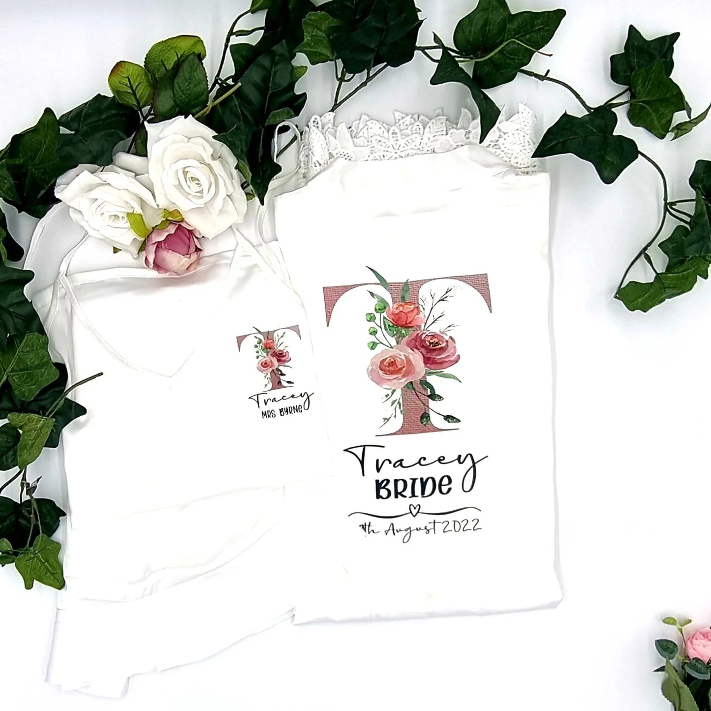 Personalised white satin bride robe with floral initial “T” and lace trim, printed and finished in Ireland by HanaLee Studios.
