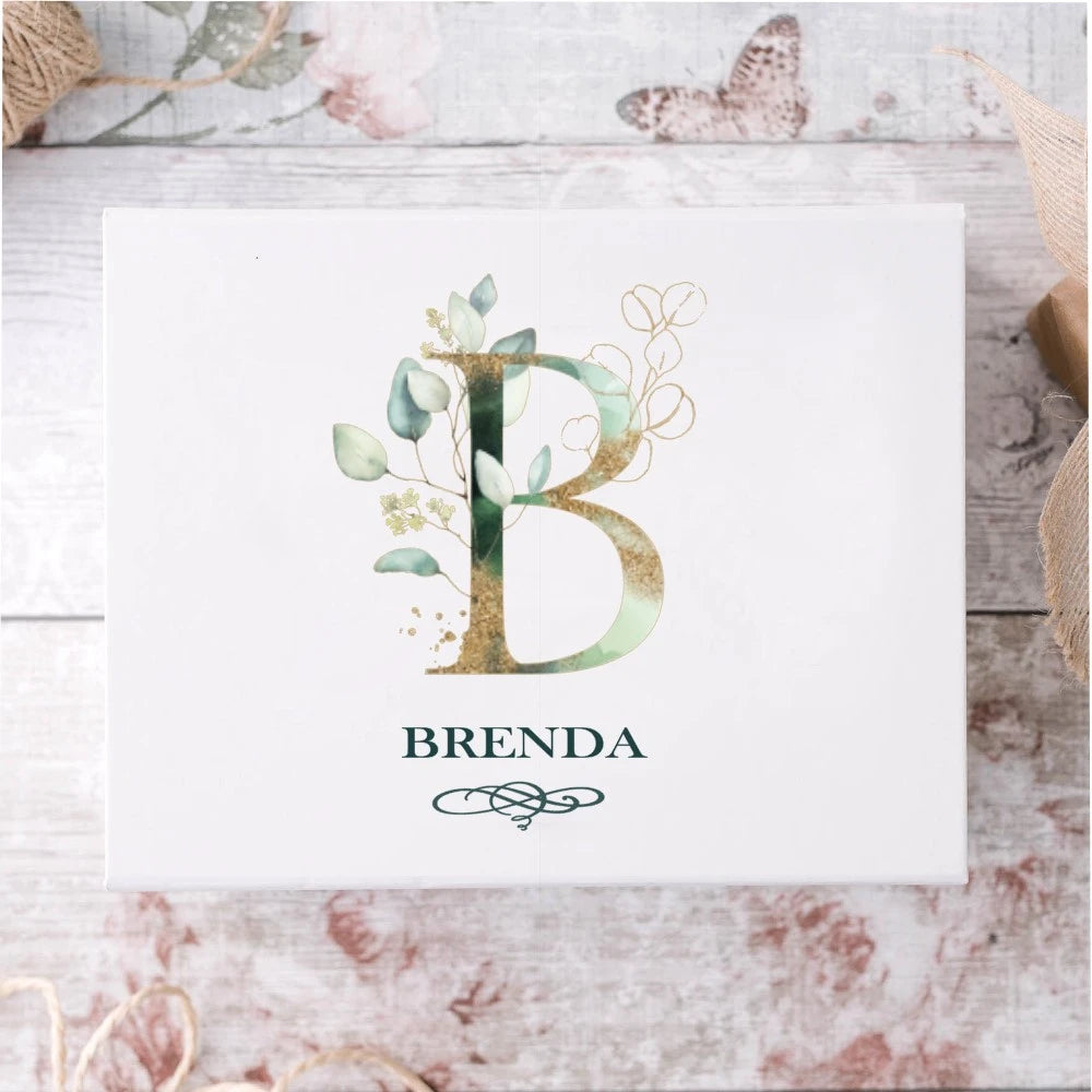 Beautiful white bridesmaid proopsal gift box with gold and green initial and name underneath.
