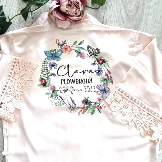 Blush pink flowergirl robe with beautiful butterfly wreath design and personalised with naem, title and date of the wedding. 