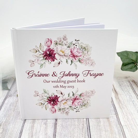 Personalised wedding guest book with pink and burgundy floral details with couples name and wedding date. 