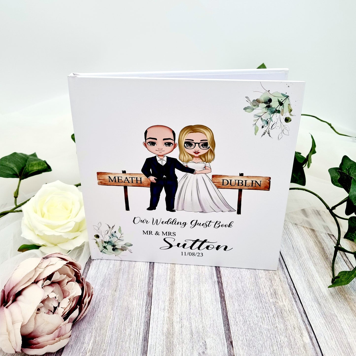 Custom wedding guest book with cartoon character bride and groom and couples wedding details 