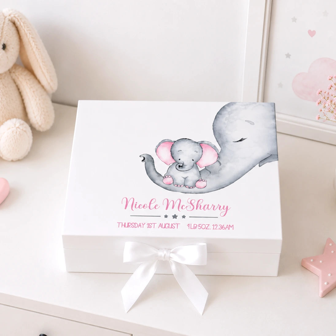 White keepsake box sitting on a white dresser in a nursery with a baby and mum elephant image and personalised with baby's details. 