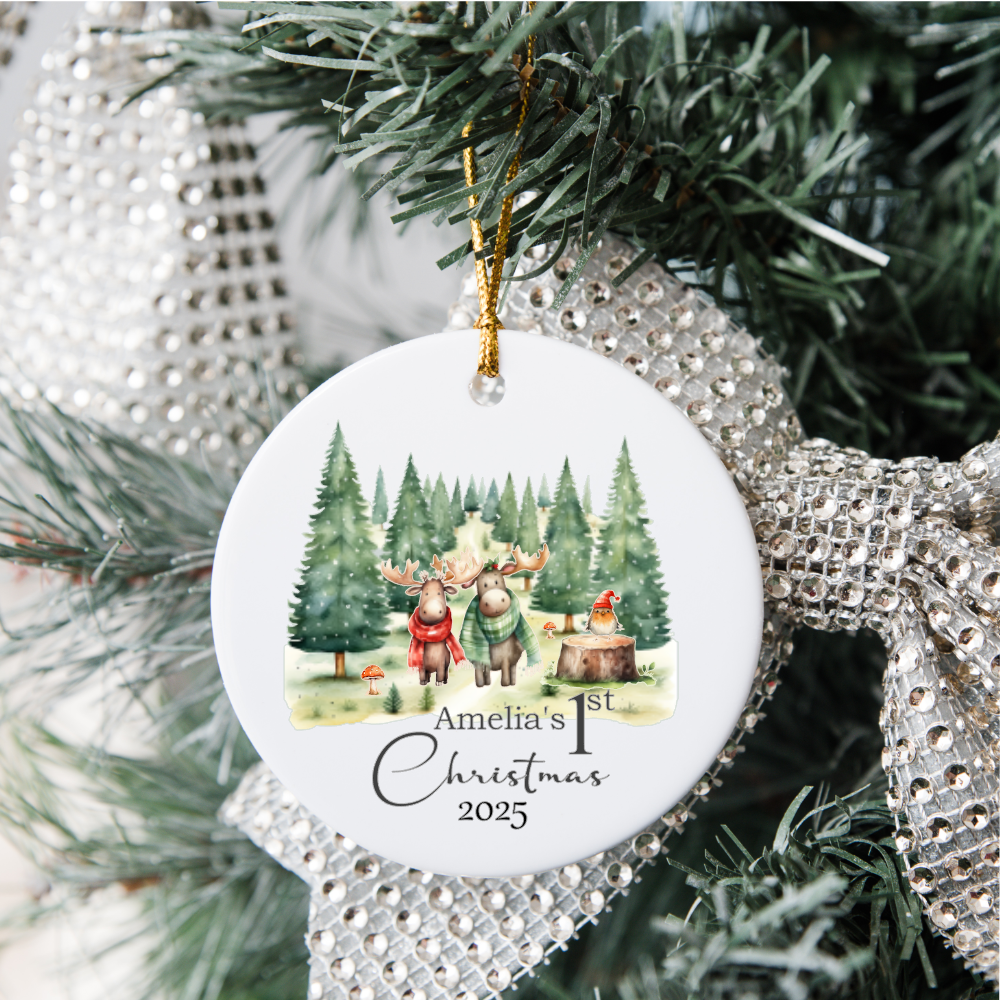 Christmas ornament with reindeer family and text 'Amelia's 1st Christmas 2025' on a decorated tree.