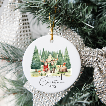 Christmas ornament with reindeer family and text 'Amelia's 1st Christmas 2025' on a decorated tree.