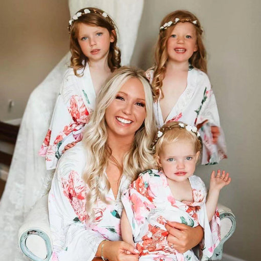 Bride with flowergirls wearing matching floral satin robes — personalised wedding robes from HanaLee Studios, Ireland