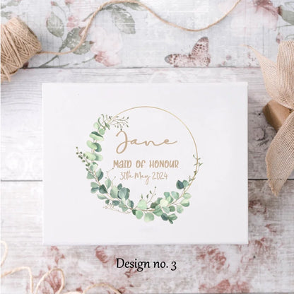 Eucalyptus wreath design on white gift box with name, title and date. 