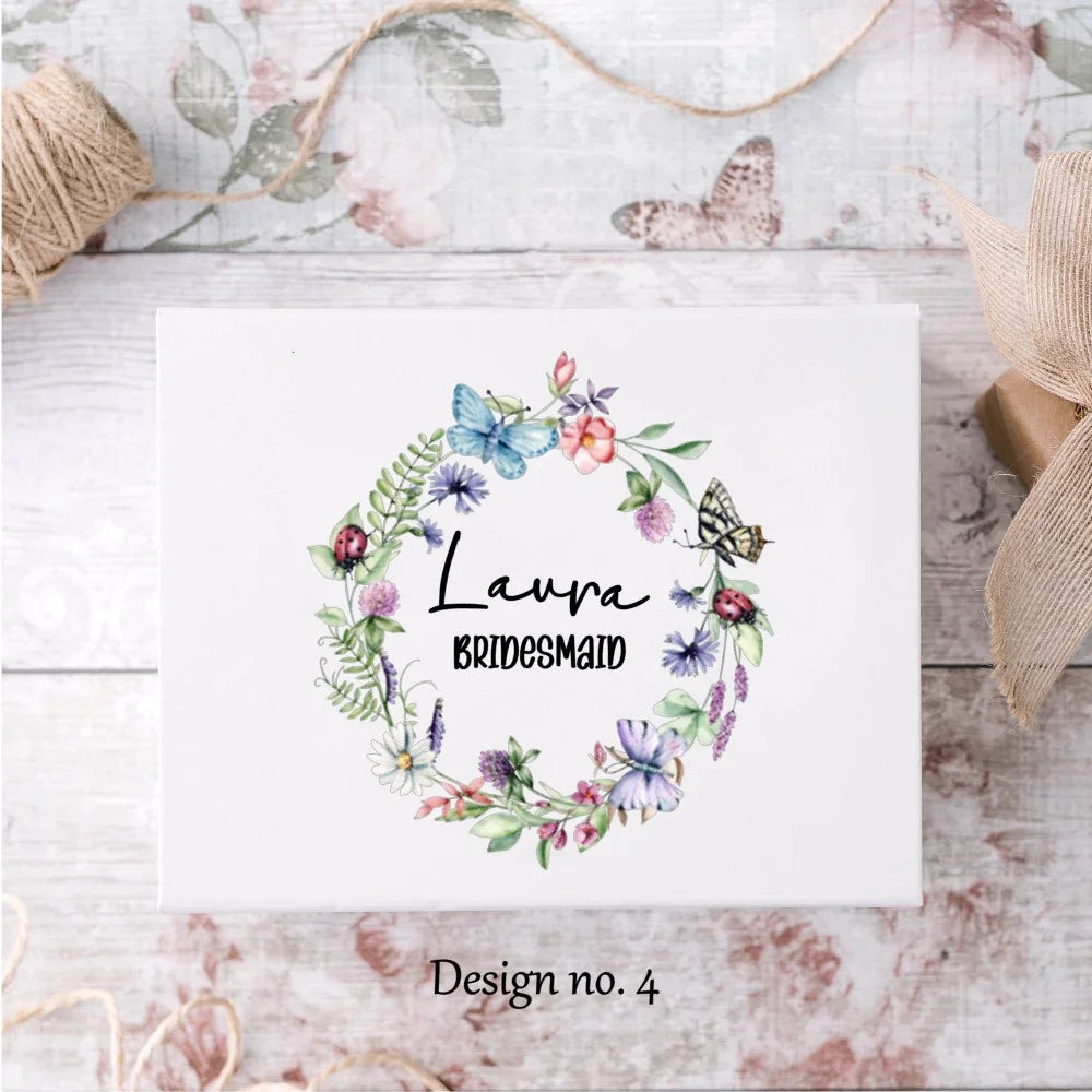 White gift box with butterfly wreath design and name and title 