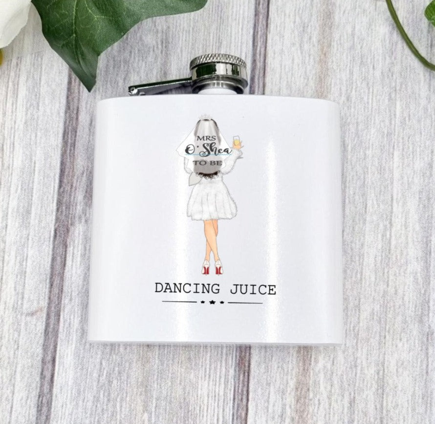 White hip flask with image of bride and personalised with brides name on her veil. Caption at the bottom reads dancing juice
