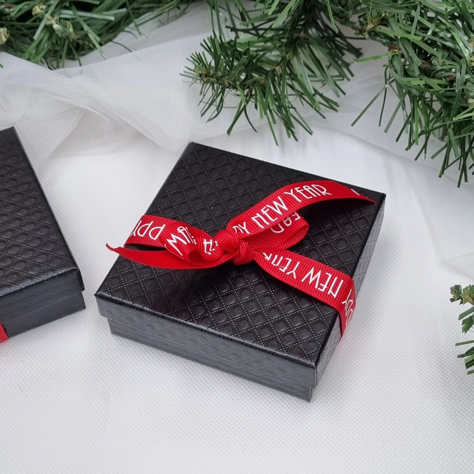 Black gift box tied with Christmas ribbon 