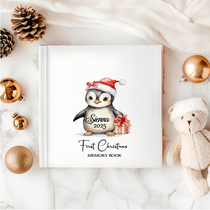 Personalised Baby’s First Christmas Memory Book with penguin in Santa hat – white hardback keepsake. 