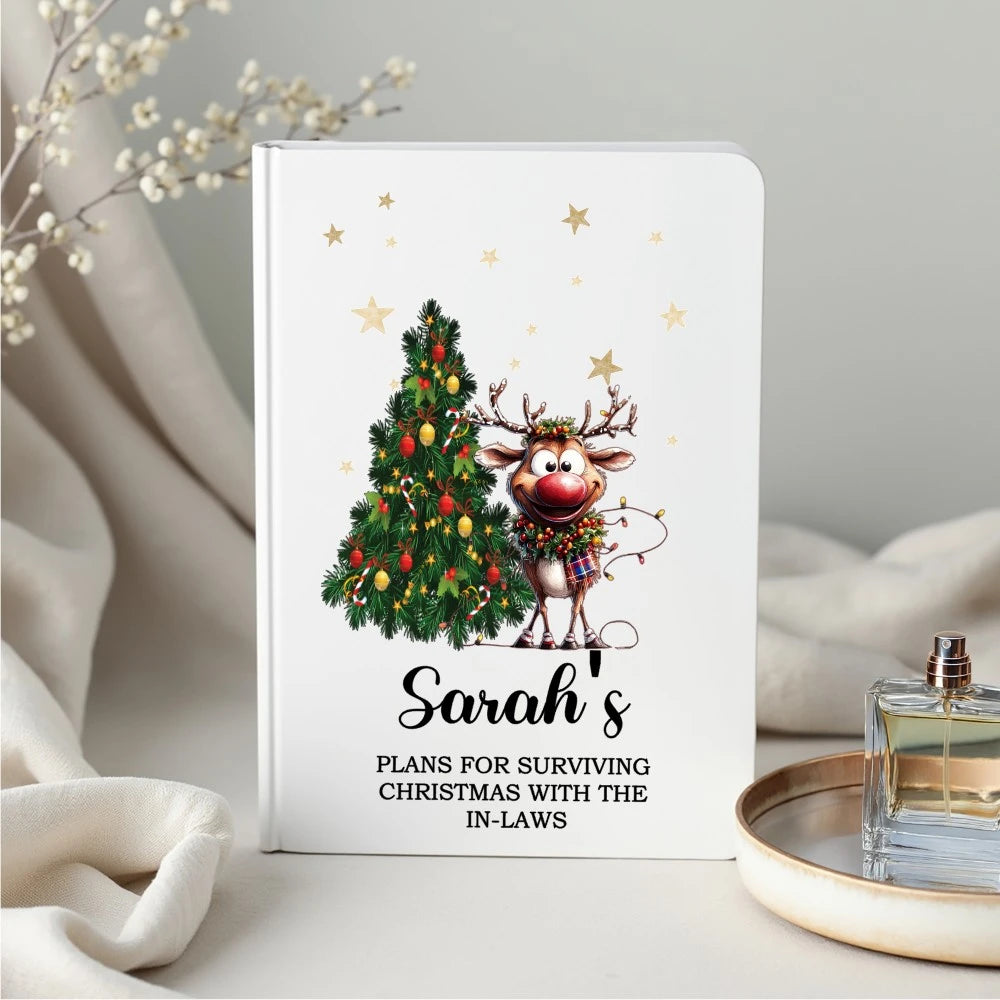 Personalised Christmas notebook with cartoon reindeer and Christmas tree design, custom name and text, printed in Ireland.