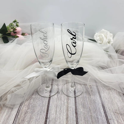 Elegant Irish-finished personalised wedding flutes displayed with floral background and tulle fabric.