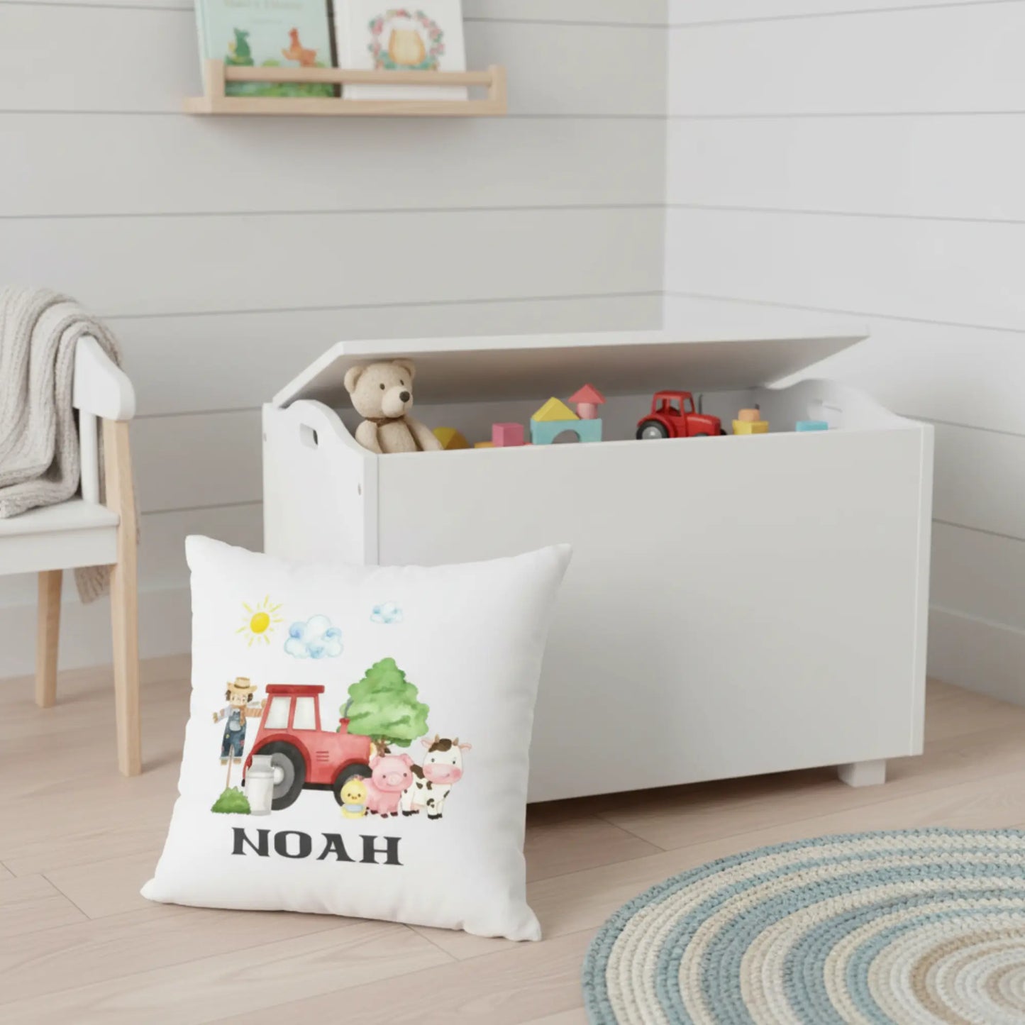 Personalised kids farm cushion with name beside a toy box 