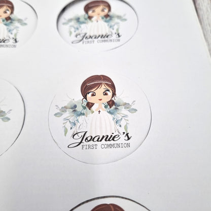 Close up view of First Communion sticker sheets with floral wreaths and script text, personalised name and date stickers