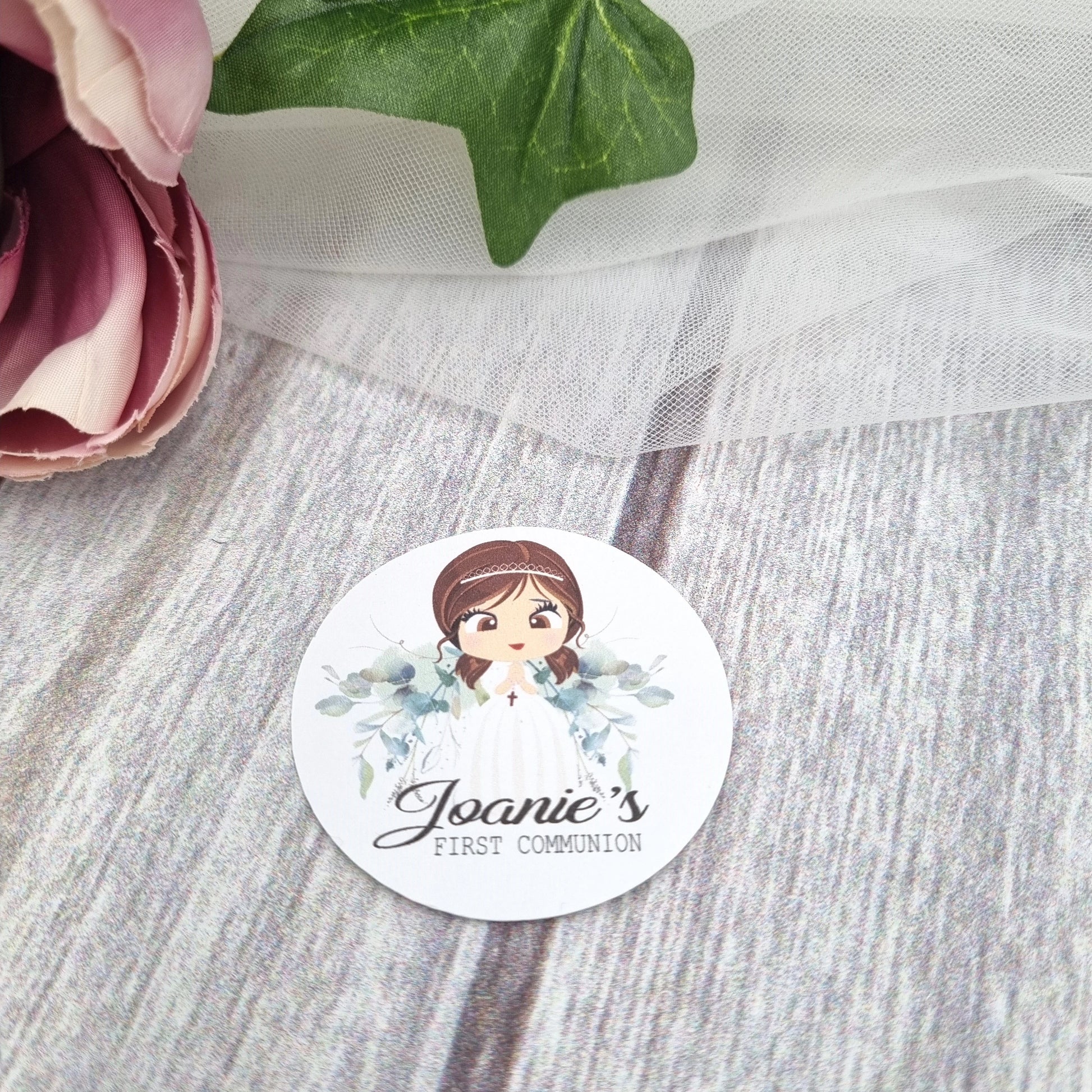 Detailed view of individual First Communion stickers including floral icons, name labels and date elements, Irish personalised