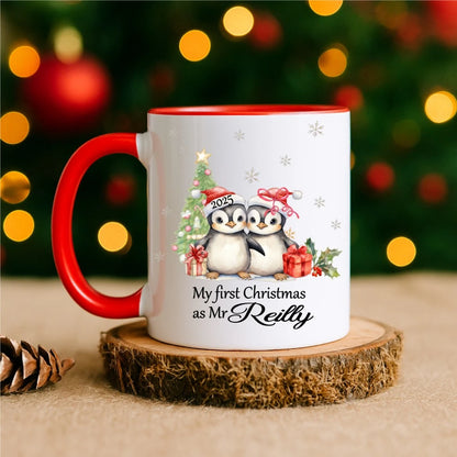 Mug with red handle reading “My First Christmas as Mr [Name]” with penguin couple illustration – personalised Christmas mug handmade in Ireland.