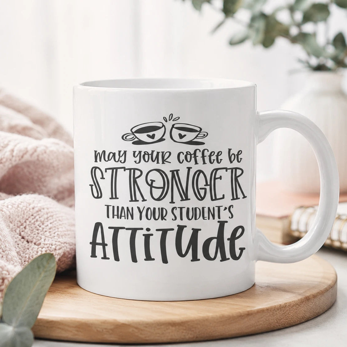 White ceramic funny teacher mug with coffee quote on wooden tray in soft neutral setting