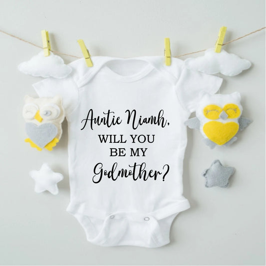 White baby onesie with 'Auntie Niamh, will you be my Godmother?' text. 