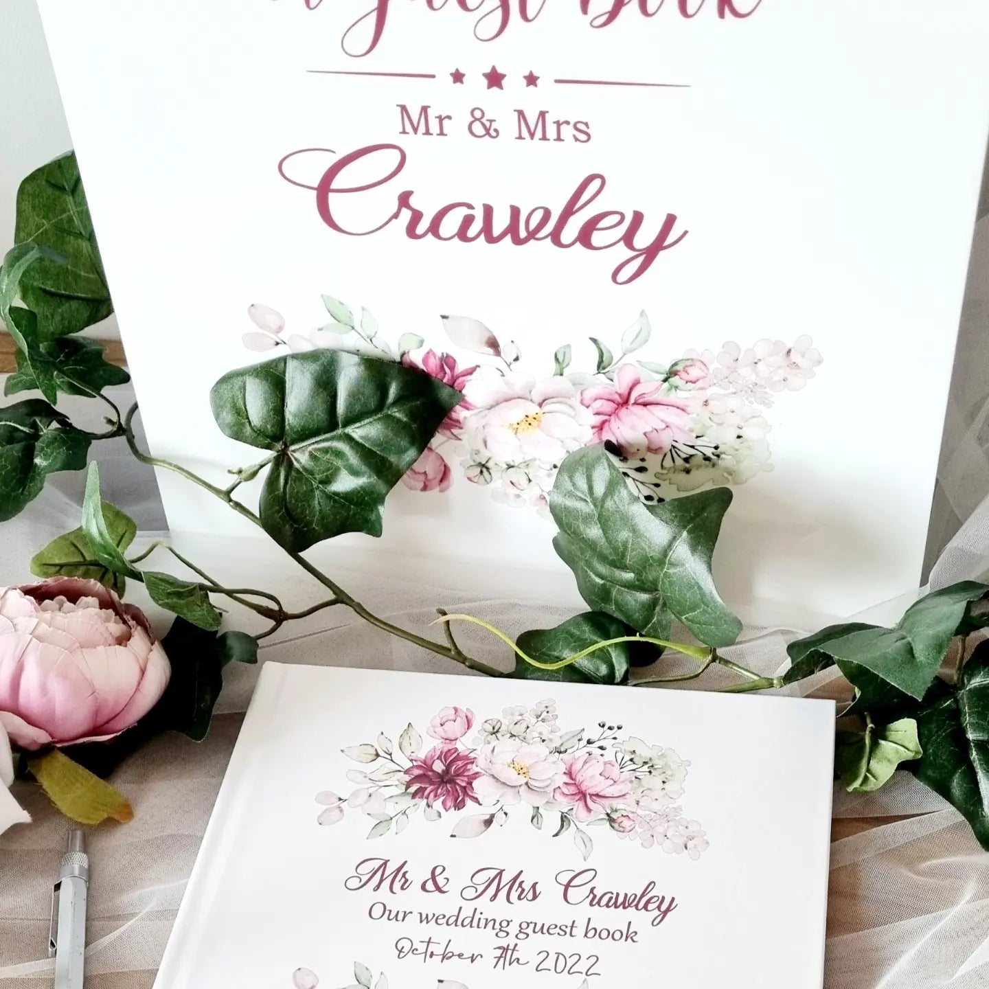 Personalised wedding guest book with pink and burgundy floral details with couples name and wedding date. Matching A3 Acrylic Sign