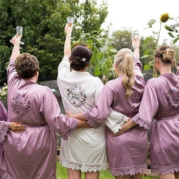 Bride and bridesmaids robes in mauve and white with butterfly wreath design