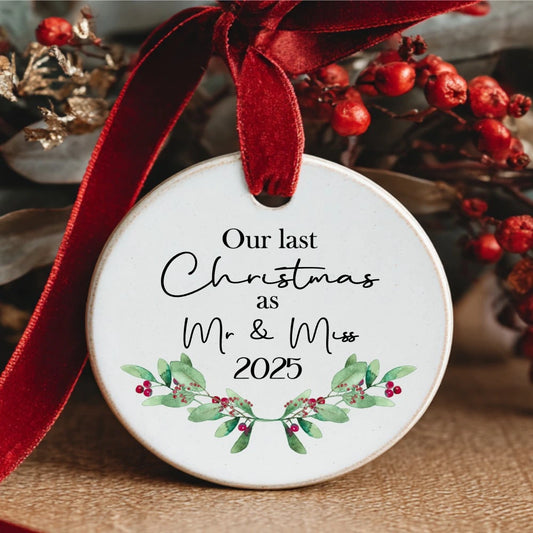 Personalised ceramic bauble with greenery design and text “Our Last Christmas as Mr & Miss 2025” – also available as Mr & Mr or Miss & Miss.