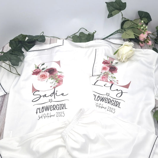 Matching personalised flowergirl pyjama sets with floral initial designs, custom printed with names and dates by HanaLee Studios in Co. Meath, Ireland.
