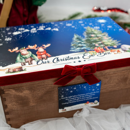 Personalised wooden Christmas Eve box with festive winter artwork, family keepsake design and red velvet ribbon photographed in a cosy Christmas setting.