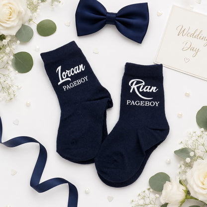 Two pairs of pageboy socks personalised with their name and title on a white background 