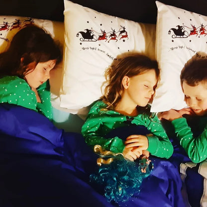 Three children asleep on a pillowcase with personalised santa silhouette and poem