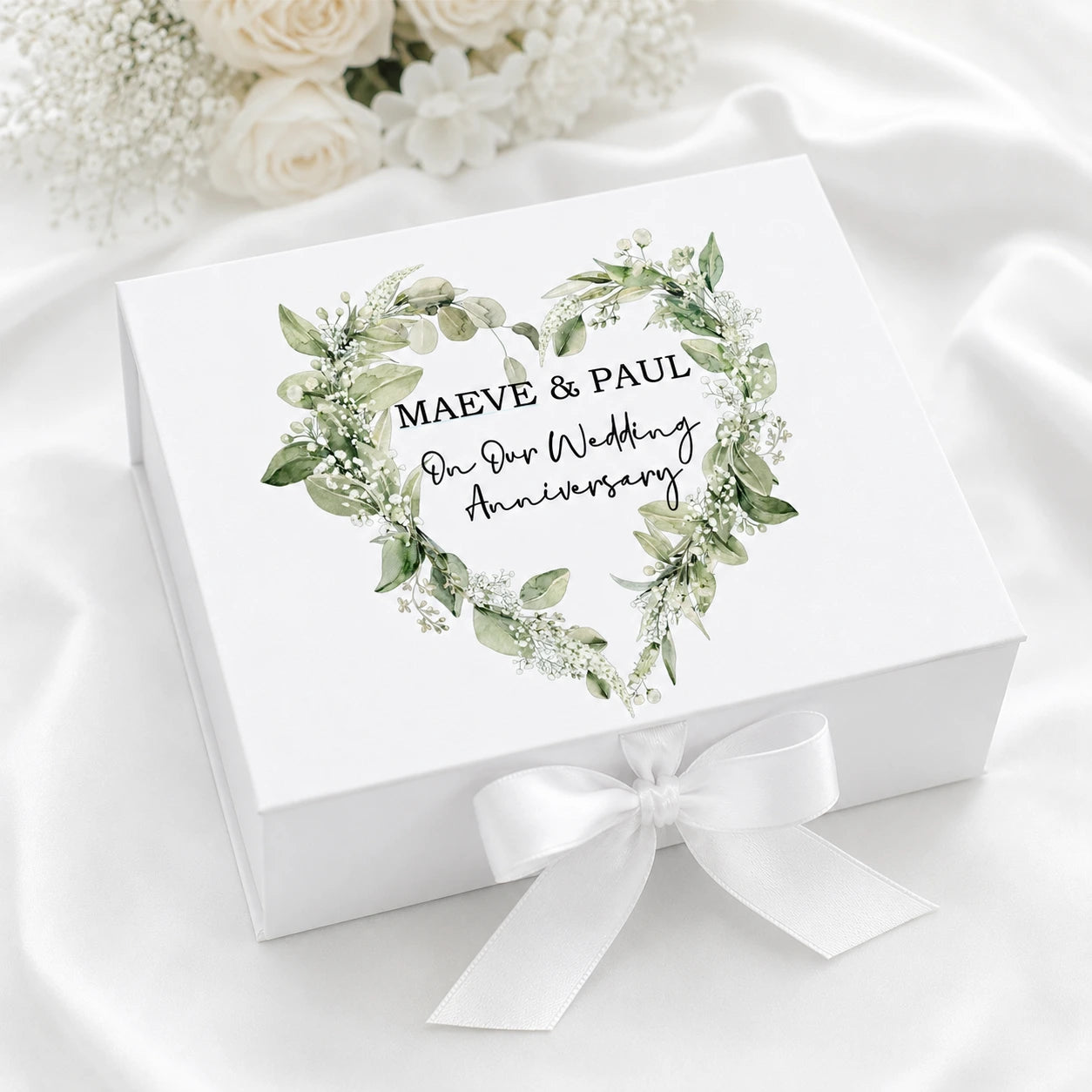 White personalised wedding anniversary card keepsake box with ribbon closure and botanical heart design for storing anniversary cards and memories.