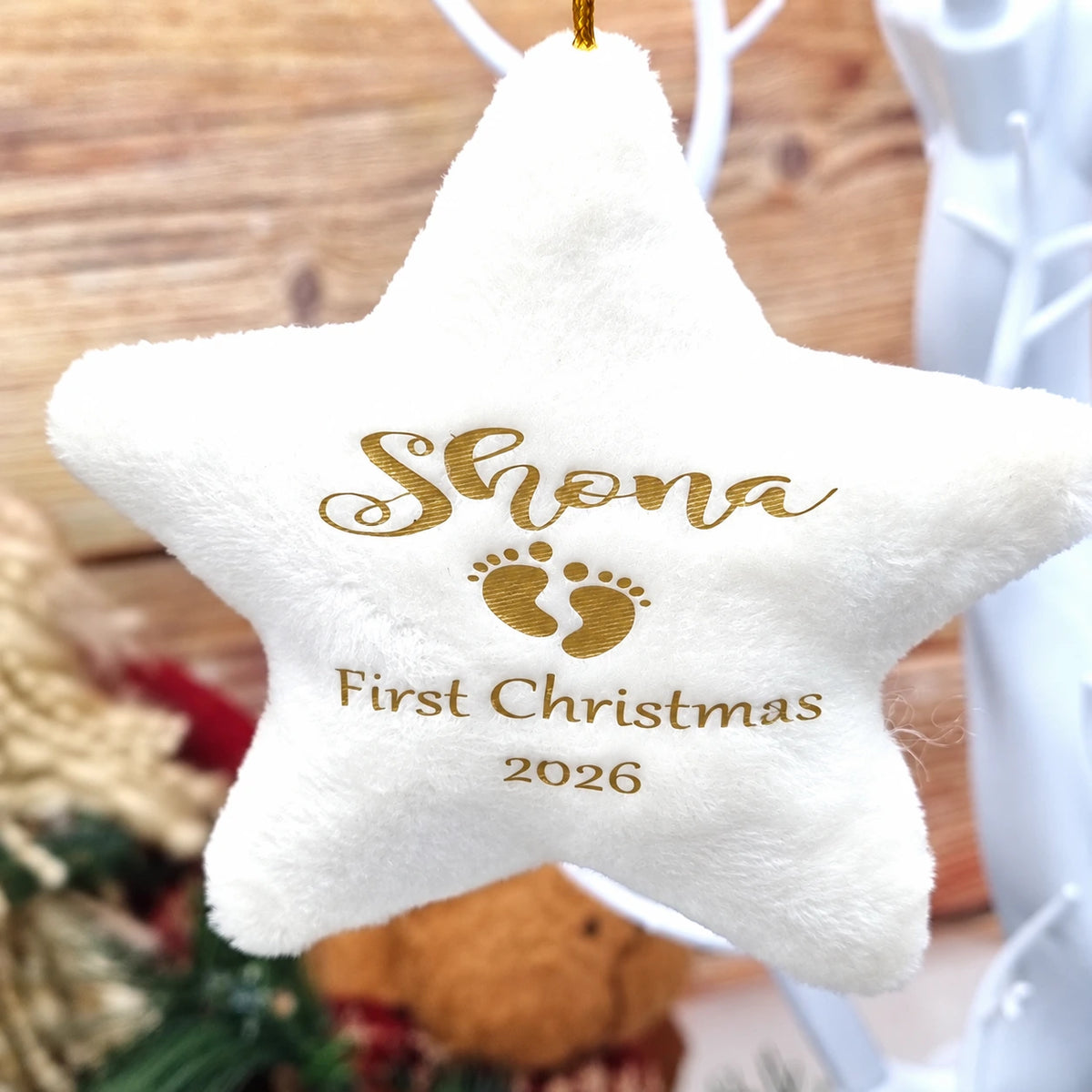 Personalised cream velvet star Christmas decoration with baby's name, footprints, Baby's First Christmas text and year 2026, with gold hanging twine.