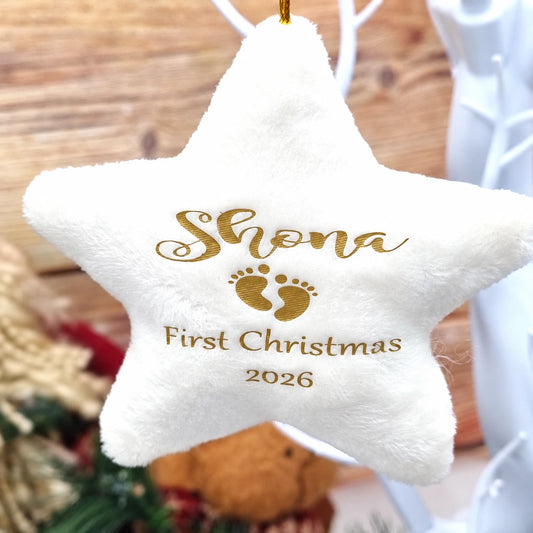 Personalised cream velvet star Christmas decoration with baby's name, footprints, Baby's First Christmas text and year 2026, with gold hanging twine.