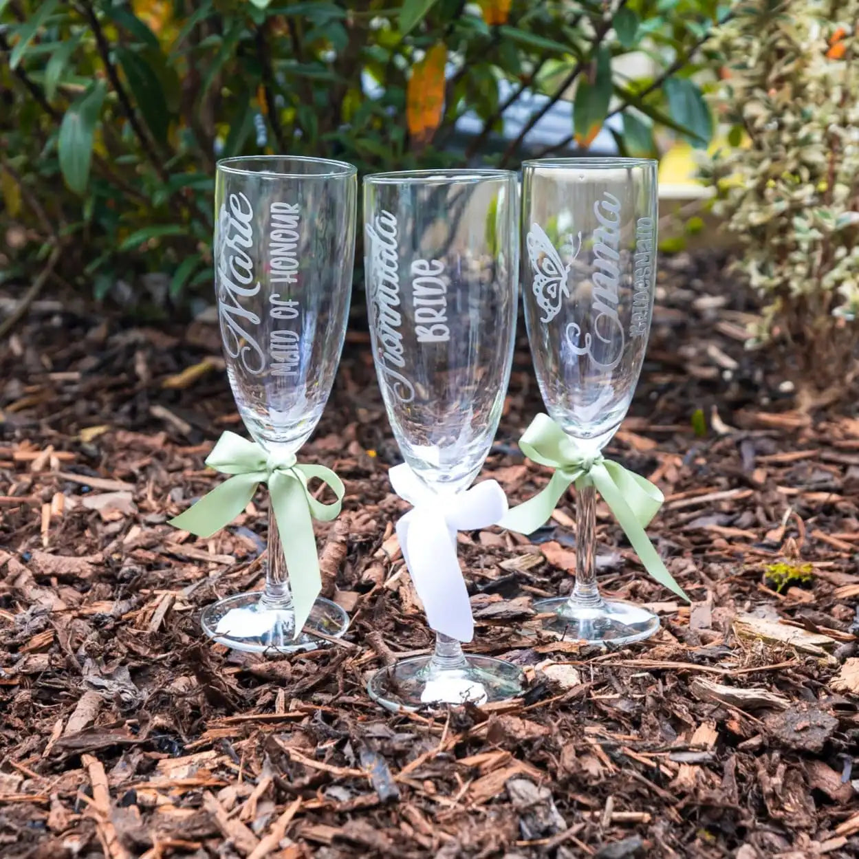 Personalised champagne flutes for bride and bridesmaids with satin ribbon