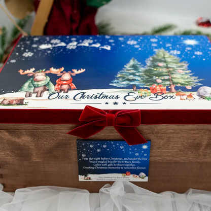 Angled lifestyle photo of a personalised Christmas Eve family box from HanaLee Studios with woodland Christmas design and luxury red velvet detailing.