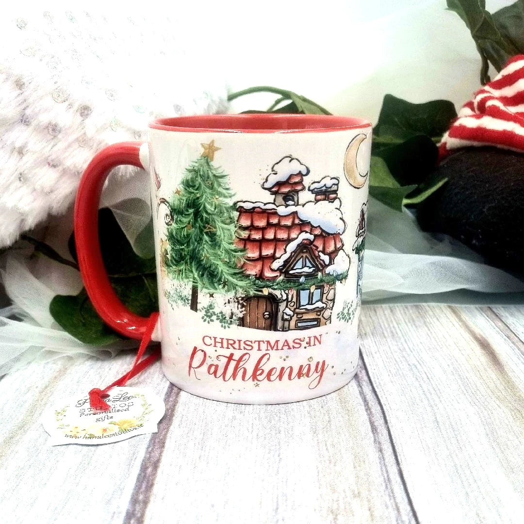 Personalised Christmas ceramic mug with colourful Christmas design, custom place name and red handle.